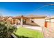 A backyard with an inviting covered patio and a small patch of artificial turf at 766 Topocoba St, Las Vegas, NV 89178