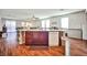 Open kitchen featuring island with sink and seating, flowing into dining and living spaces at 766 Topocoba St, Las Vegas, NV 89178
