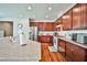 Modern kitchen with stainless steel appliances, granite countertops, and dark wood cabinets at 766 Topocoba St, Las Vegas, NV 89178