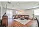 Spacious living room with a large brown leather couch and stylish area rug at 766 Topocoba St, Las Vegas, NV 89178