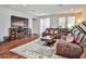 Inviting living room with a brown leather sectional, TV, and access to the backyard at 766 Topocoba St, Las Vegas, NV 89178