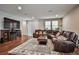 Spacious living room with a large sectional, fireplace, and lots of natural light from the big windows at 766 Topocoba St, Las Vegas, NV 89178