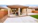 Relaxing covered patio featuring a grill, adjacent to the low maintenance backyard at 766 Topocoba St, Las Vegas, NV 89178