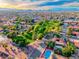 Expansive aerial view of a vibrant Las Vegas community with tree-lined streets and a distant skyline at 7670 Descanso Ln, Las Vegas, NV 89123