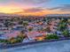 Panoramic aerial view of a Las Vegas neighborhood at sunset with city skyline at 7670 Descanso Ln, Las Vegas, NV 89123