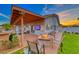 Inviting covered patio with a fire pit, seating, and TV, perfect for outdoor entertaining at 7670 Descanso Ln, Las Vegas, NV 89123