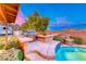 Well-maintained backyard with built-in BBQ, water feature, and lush greenery at 7670 Descanso Ln, Las Vegas, NV 89123