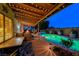 Relaxing outdoor living space with covered patio, string lights, and beautiful pool at 7670 Descanso Ln, Las Vegas, NV 89123