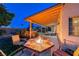 Charming backyard with fire pit, covered patio, and inviting pool area at 7670 Descanso Ln, Las Vegas, NV 89123