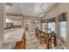 Elegant dining area with a long table, modern chandelier, and seamless access to the kitchen at 7670 Descanso Ln, Las Vegas, NV 89123