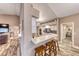 Kitchen with tiled breakfast bar, white cabinets, black backsplash, and stainless appliances at 7670 Descanso Ln, Las Vegas, NV 89123