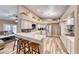 Modern kitchen featuring stainless steel appliances, white cabinets, and a breakfast bar at 7670 Descanso Ln, Las Vegas, NV 89123
