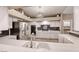 Kitchen featuring stainless steel appliances, white cabinets, and a stylish backsplash at 7670 Descanso Ln, Las Vegas, NV 89123