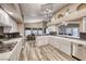 Open kitchen with white cabinets, stainless steel appliances, and breakfast bar at 7670 Descanso Ln, Las Vegas, NV 89123