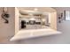 An arched, open kitchen view featuring white cabinets and dark backsplash at 7670 Descanso Ln, Las Vegas, NV 89123