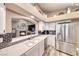 Well-equipped kitchen with stainless steel refrigerator and a fireplace view at 7670 Descanso Ln, Las Vegas, NV 89123
