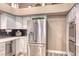 Kitchen area with stainless steel refrigerator and appliances, and white cabinets at 7670 Descanso Ln, Las Vegas, NV 89123