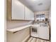 Well-organized laundry room with storage cabinets, counter space, washer, and dryer at 7670 Descanso Ln, Las Vegas, NV 89123