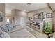 Bright living room featuring a stylish fireplace, neutral decor, and open access to other spaces at 7670 Descanso Ln, Las Vegas, NV 89123