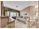 Comfortable living room featuring a large sectional sofa, bay window, and stylish decor elements at 7670 Descanso Ln, Las Vegas, NV 89123