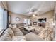 Bright living room with a large sectional sofa, fireplace, and natural light at 7670 Descanso Ln, Las Vegas, NV 89123