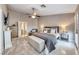 Bright main bedroom with seating area, king bed, ceiling fan, and neutral décor at 7670 Descanso Ln, Las Vegas, NV 89123