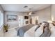 Relaxing main bedroom featuring a king bed, sitting area, and ensuite bathroom at 7670 Descanso Ln, Las Vegas, NV 89123