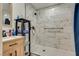 Modern bathroom showcasing marble-look tile shower, wood vanity, and sleek fixtures for a luxurious feel at 7950 Red Barn Dr, Las Vegas, NV 89123