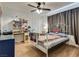Bedroom with a bed and desk area, featuring wood-look flooring at 7950 Red Barn Dr, Las Vegas, NV 89123