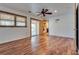 A bright bedroom with wood floors, ceiling fan and door to the exterior at 7950 Red Barn Dr, Las Vegas, NV 89123
