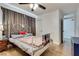 Cozy bedroom featuring a metal bed frame, ceiling fan, and light wood-look flooring, creating a relaxing atmosphere at 7950 Red Barn Dr, Las Vegas, NV 89123