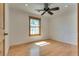 A bright bedroom with wood floors, ceiling fan and lots of light from the window at 7950 Red Barn Dr, Las Vegas, NV 89123