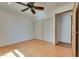 This bright bedroom has wood floors, a ceiling fan, a closet and a door at 7950 Red Barn Dr, Las Vegas, NV 89123