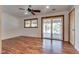 A spacious bedroom with wood floors, ceiling fan and a sliding glass door to the exterior at 7950 Red Barn Dr, Las Vegas, NV 89123