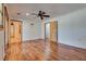 A bright bedroom with wood floors, ceiling fan and two doors at 7950 Red Barn Dr, Las Vegas, NV 89123