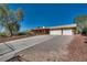 Attractive single-story home with a long driveway, a two-car garage, and appealing front yard landscaping at 7950 Red Barn Dr, Las Vegas, NV 89123