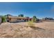 Charming home exterior featuring wood siding, a covered porch, and ample yard space at 7950 Red Barn Dr, Las Vegas, NV 89123