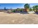 Home exterior with covered porch and natural desert landscaping, offering charm and curb appeal at 7950 Red Barn Dr, Las Vegas, NV 89123