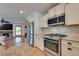 Kitchen with stainless steel appliances and views of the living room and fireplace at 7950 Red Barn Dr, Las Vegas, NV 89123