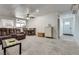 Cozy living room features plush seating, carpet, and a view to the dining area and kitchen at 7950 Red Barn Dr, Las Vegas, NV 89123