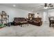 Cozy living room with plush sofas, a ceiling fan, and ample natural light at 7950 Red Barn Dr, Las Vegas, NV 89123