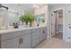 Modern bathroom featuring double vanity, white countertops, sleek fixtures, and a glass-enclosed shower at 7983 Texas Hills St, Las Vegas, NV 89113