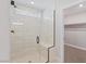 Bright bathroom featuring a glass shower, tiled walls, and a built-in bench at 7983 Texas Hills St, Las Vegas, NV 89113