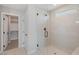 Modern bathroom with a glass-enclosed shower showcasing white subway tile and a view of a walk-in closet at 7983 Texas Hills St, Las Vegas, NV 89113