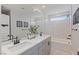 Bright bathroom featuring double sinks, modern fixtures, and a shower-tub combination with white tile at 7983 Texas Hills St, Las Vegas, NV 89113