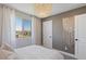 This bedroom has a macrame wall decoration, chandelier and window at 7983 Texas Hills St, Las Vegas, NV 89113