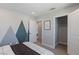 This bedroom features a modern mountain themed wall design and a closet at 7983 Texas Hills St, Las Vegas, NV 89113