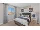 Cozy bedroom with neighborhood views, modern decor, and a comfortable bed with side tables at 7983 Texas Hills St, Las Vegas, NV 89113