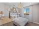 This bedroom features a decorative light fixture and a window at 7983 Texas Hills St, Las Vegas, NV 89113