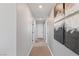 Neutral hallway showcasing modern decor and doors leading to various rooms in the house at 7983 Texas Hills St, Las Vegas, NV 89113